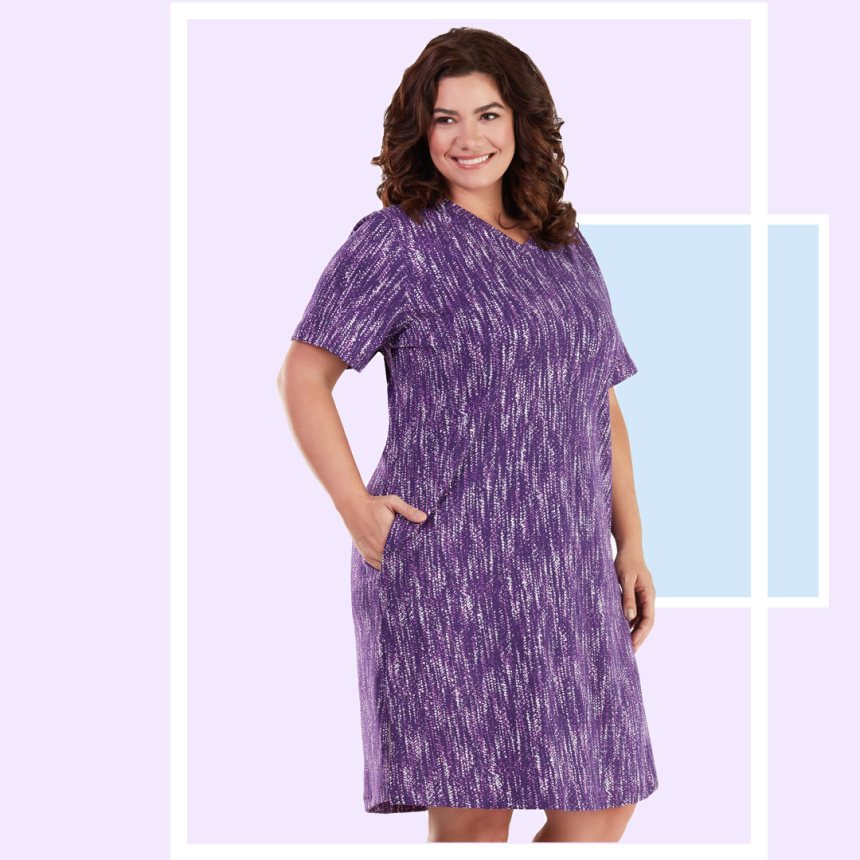 Plus size woman wearing purple JunoActive plus size dress.